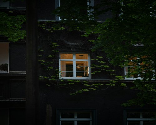 Person enjoying a quiet morning coffee by the window in a Polish apartment